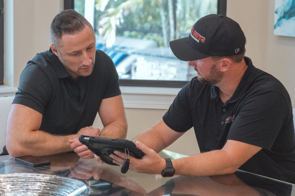 Three Guys Master Tradesmen technician reviewing repair and replacement options with a homeowner