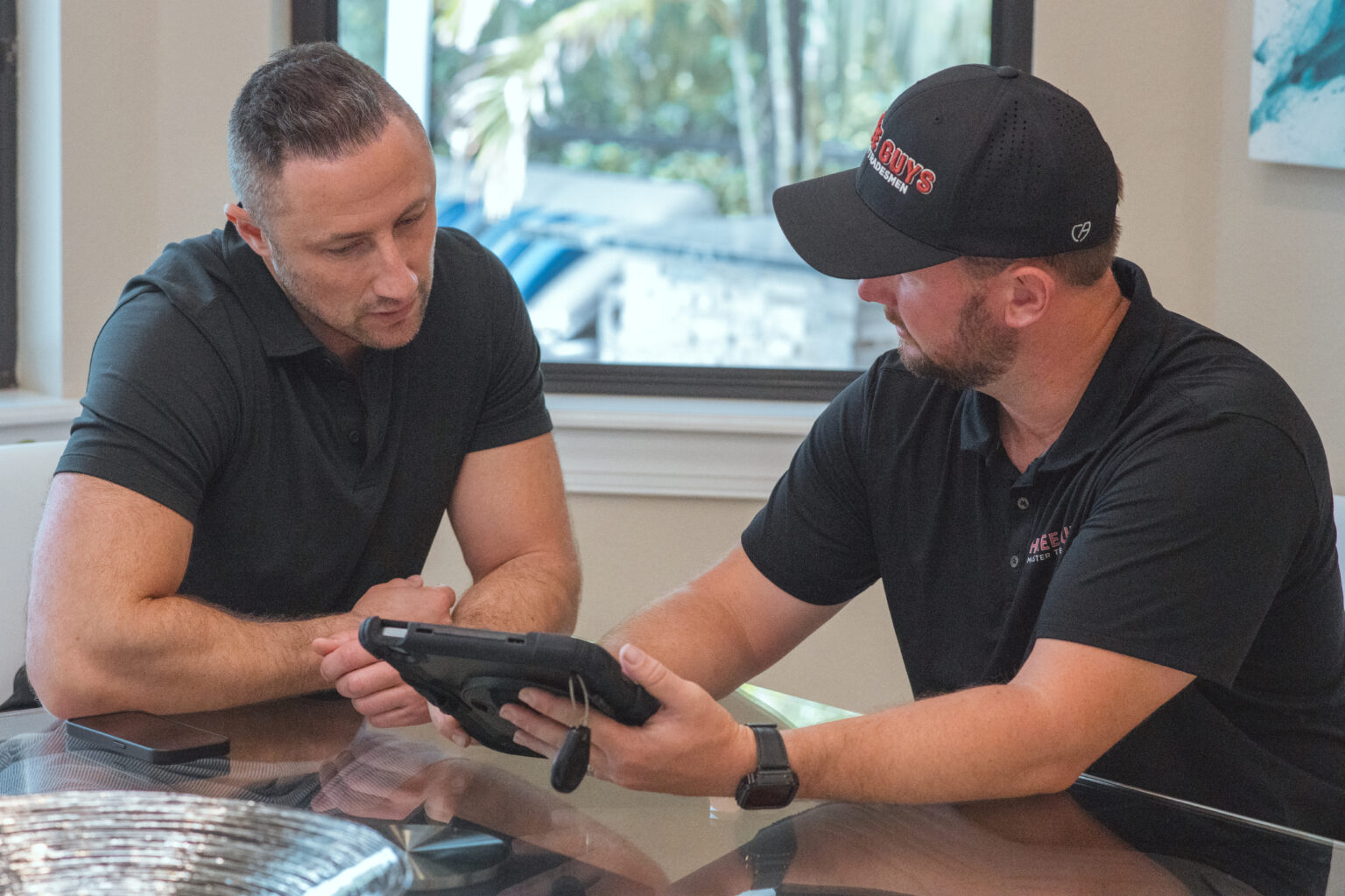 Three Guys Master Tradesmen technician reviewing repair and replacement options with a homeowner