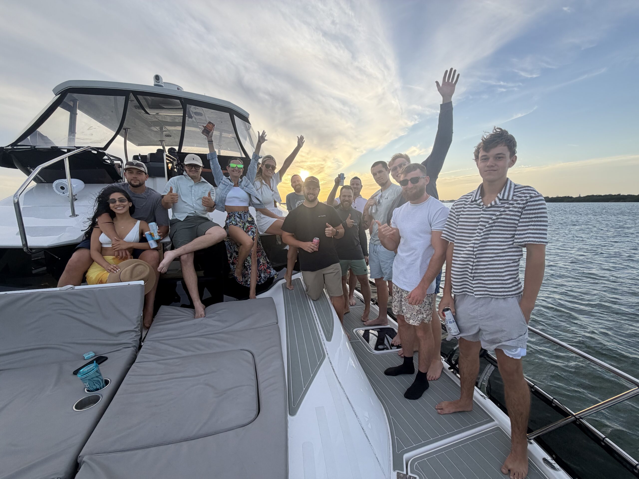 Three Guys Master Tradesmen team enjoying a group boat outing at sunset