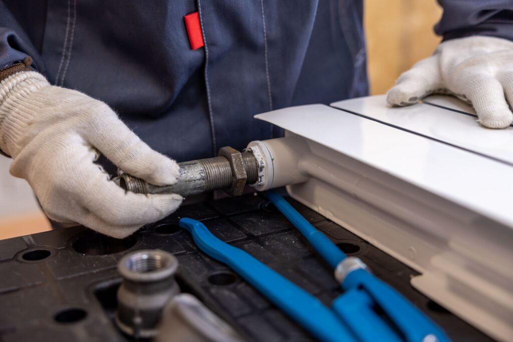 Plumber connecting a pipe fitting to a radiator valve