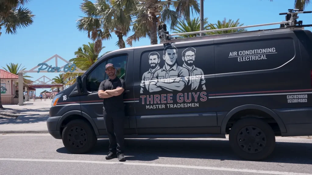 Three Guys Master Tradesmen owner with a branded AC service van at Pier 60 on Clearwater Beach, FL